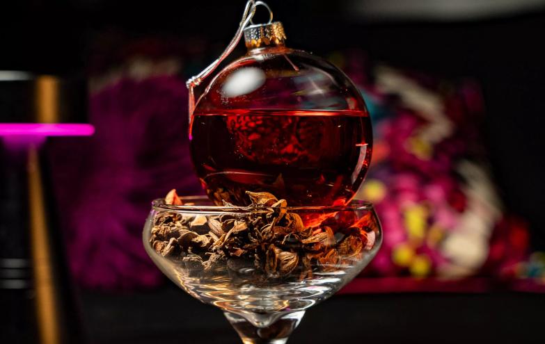 A holiday cocktail at Rosa Sky looks like a red Christmas ornament