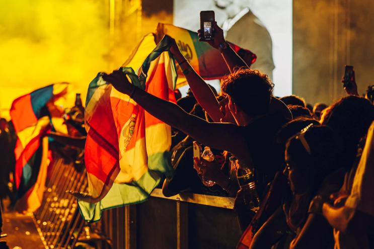 An audience member waves a flag at the Vibra Urbana music festival in Miami
