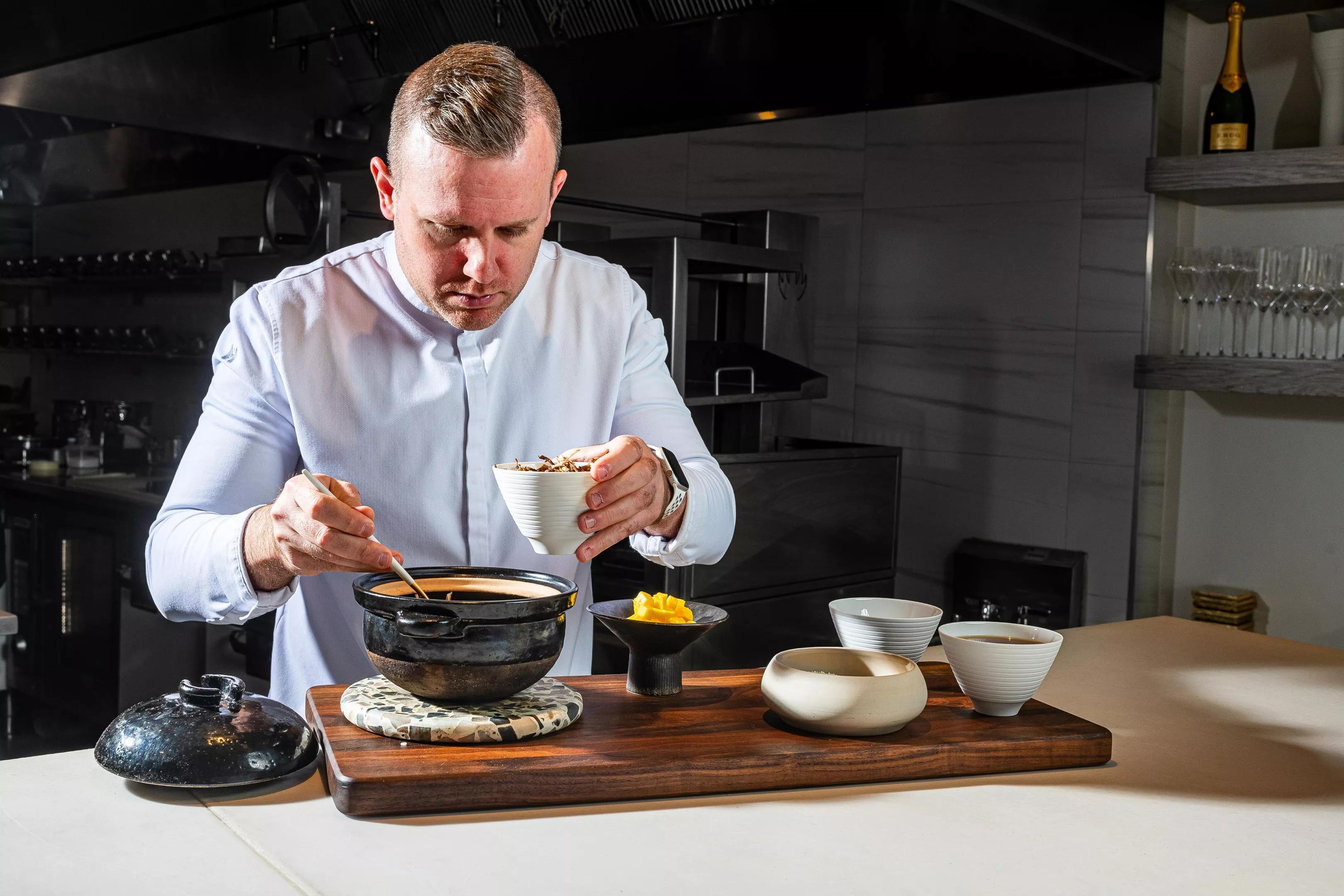 Michelin-strarred chef Ryan Ratino cooks food in a pan.