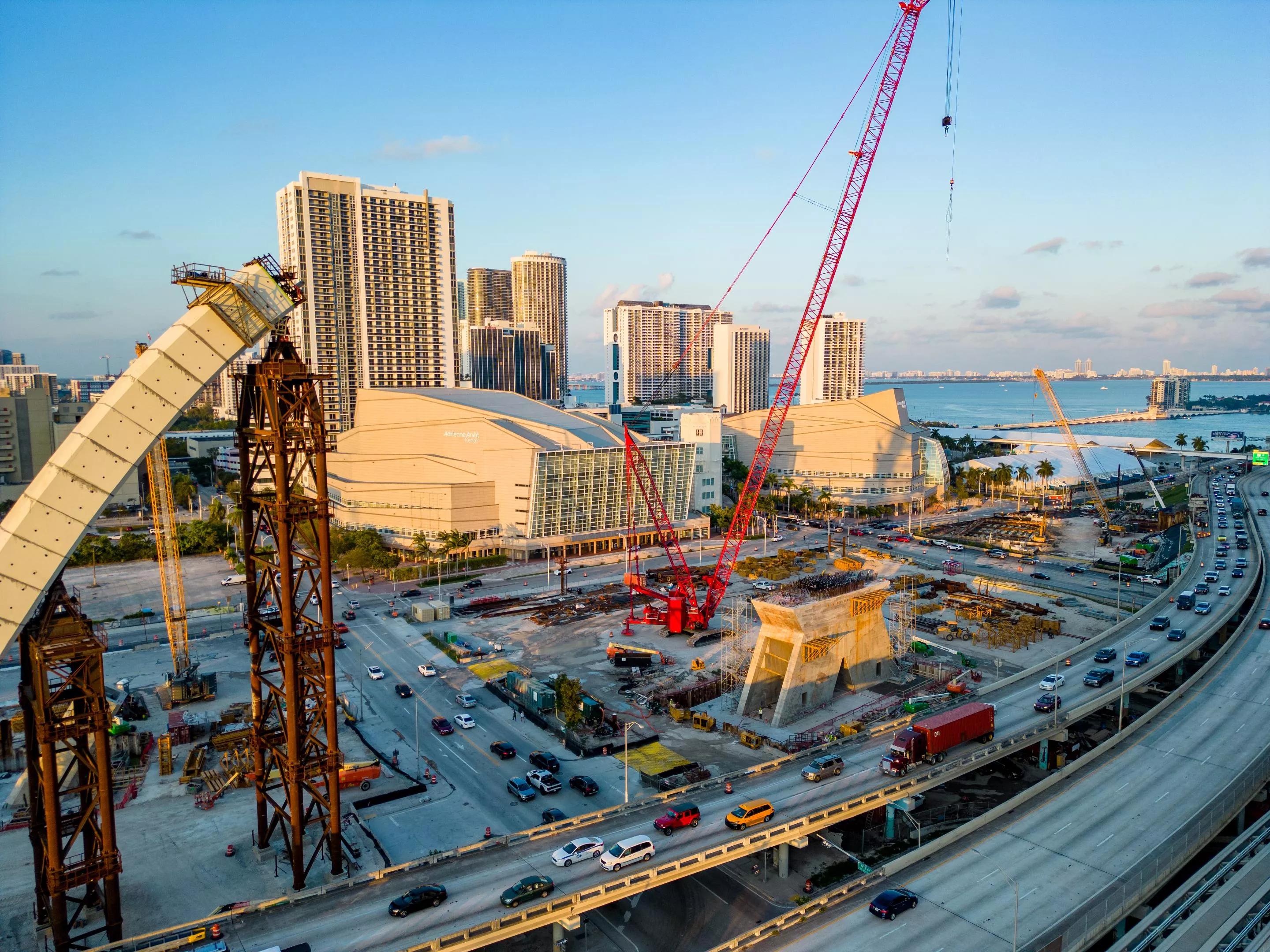 Highway traffic flowing in downtown Miami near a massive construction project