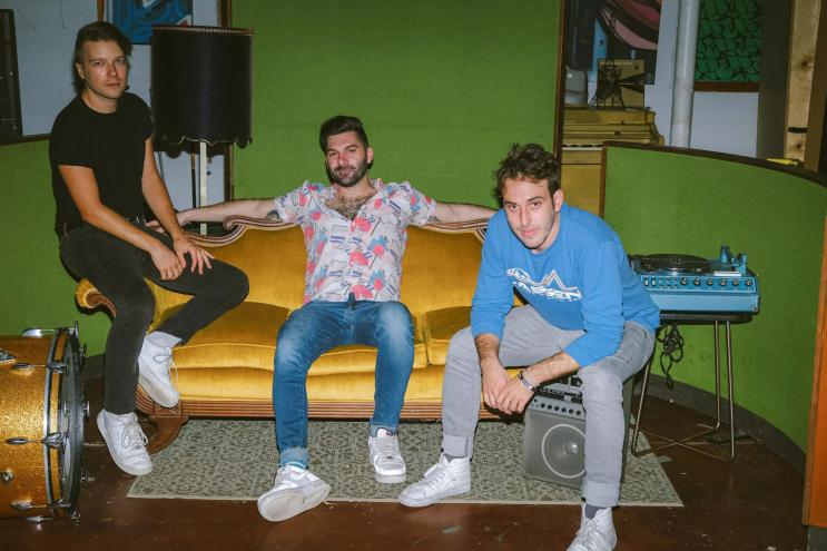 The members of the Magic City Hippies sitting on a couch