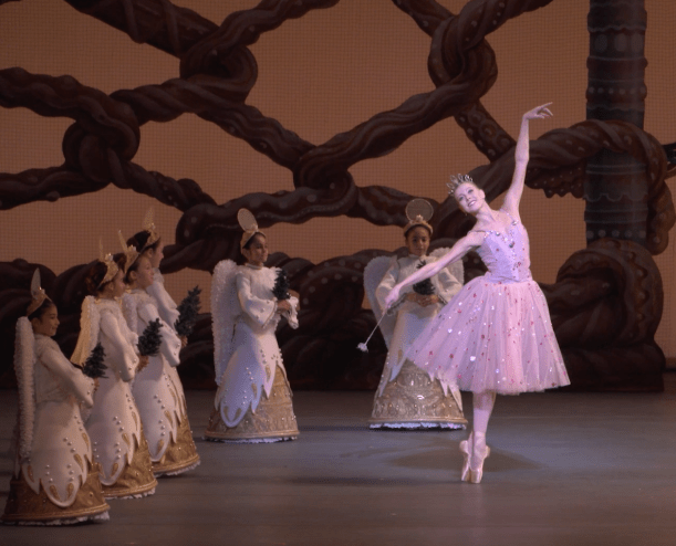 Miami City Ballet principal dancer Dawn Atkins dancing in The Nutcracker, surrounded by young dancers dressed as angels