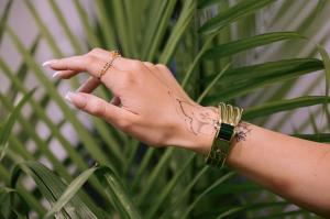 A hand models an ornate bracelet