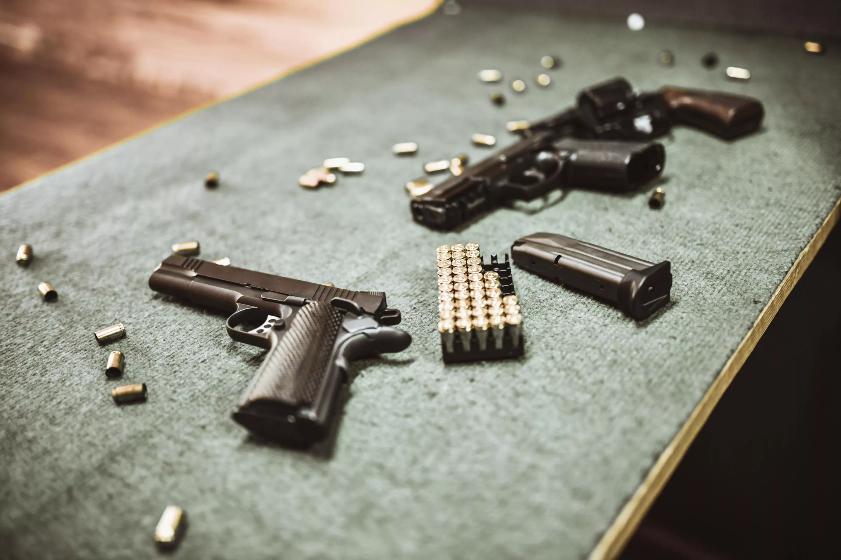 guns and bullets on a table