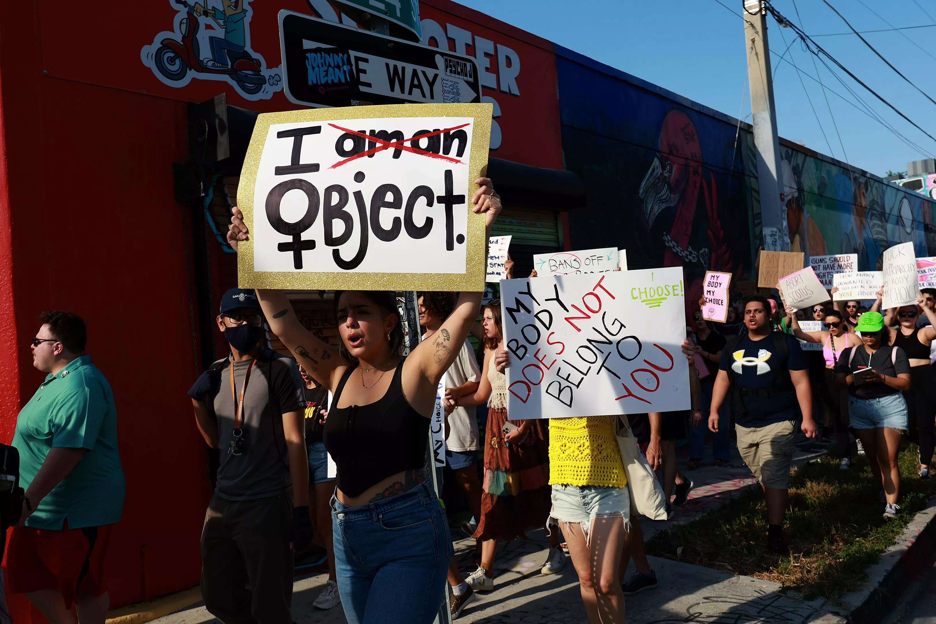 Abortion rights protesters holding signs march in Florida