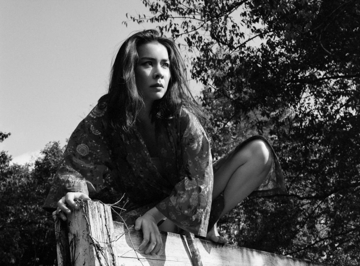 Mitski in front of a tree