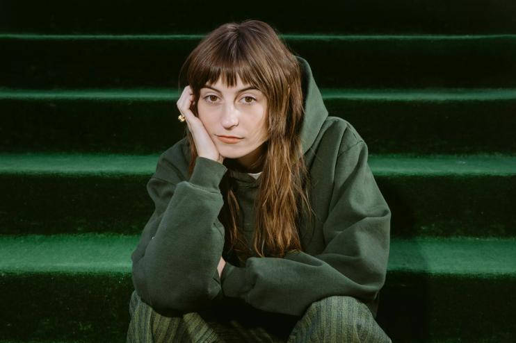 faye webster in a green sweater