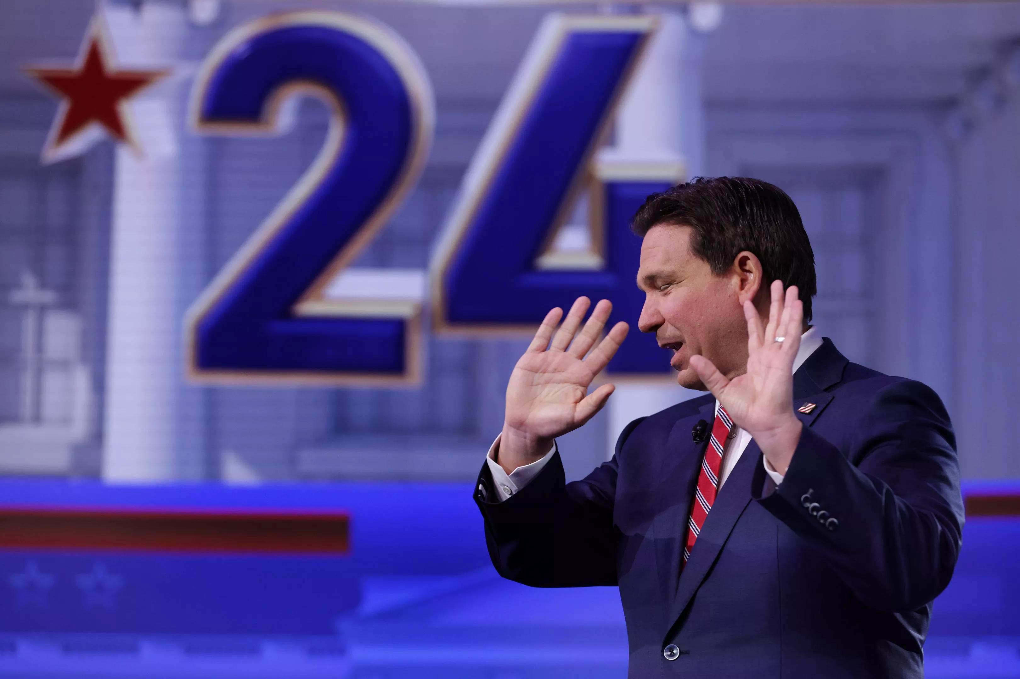 Florida Gov. Ron DeSantis raises his open hands during a town hall event in January 2024.