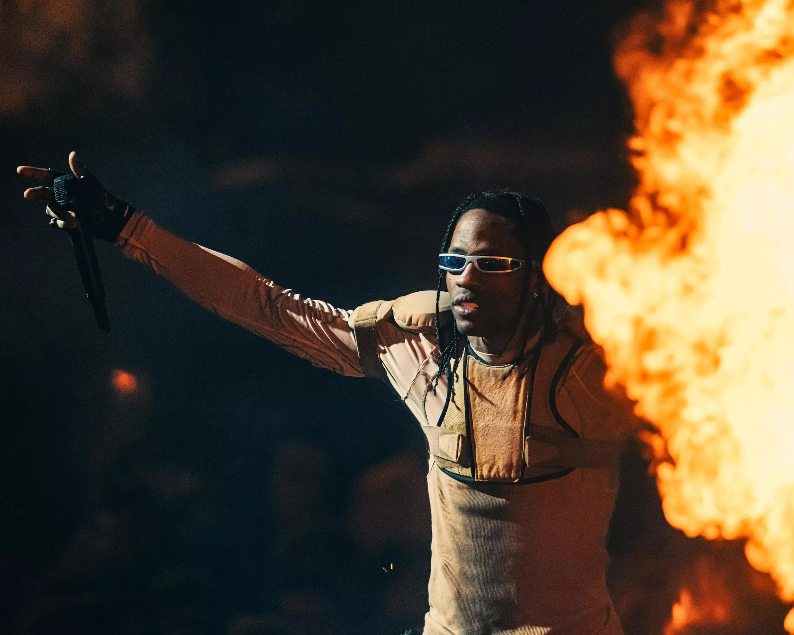 Travis Scott performing at the Kaseya Center as pyrotechnics go off