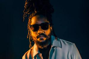 headshot of kabaka pyramid in a jean jacket