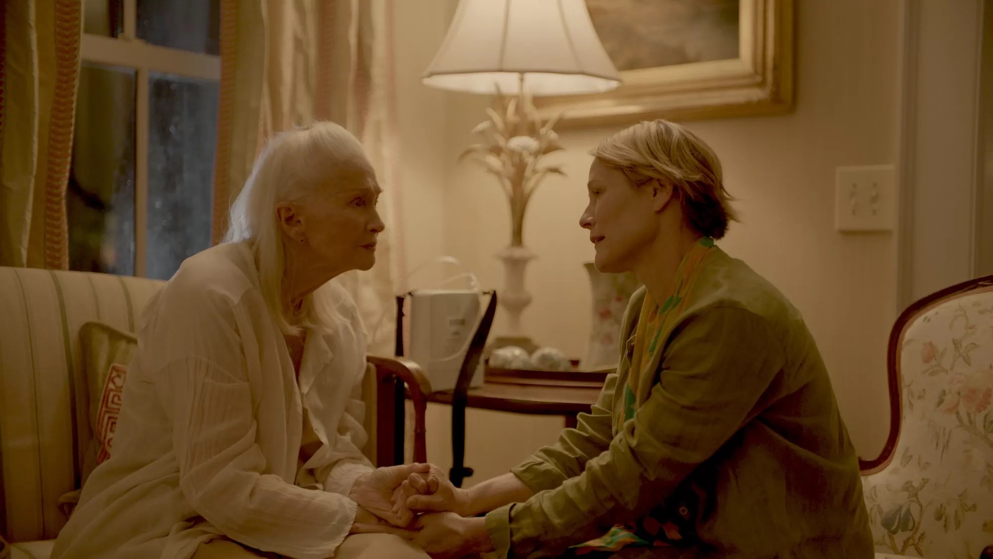 Actresses Diane Ladd and Mary Stuart Masterson sitting across from each other in a scene in "Isle of Hope"