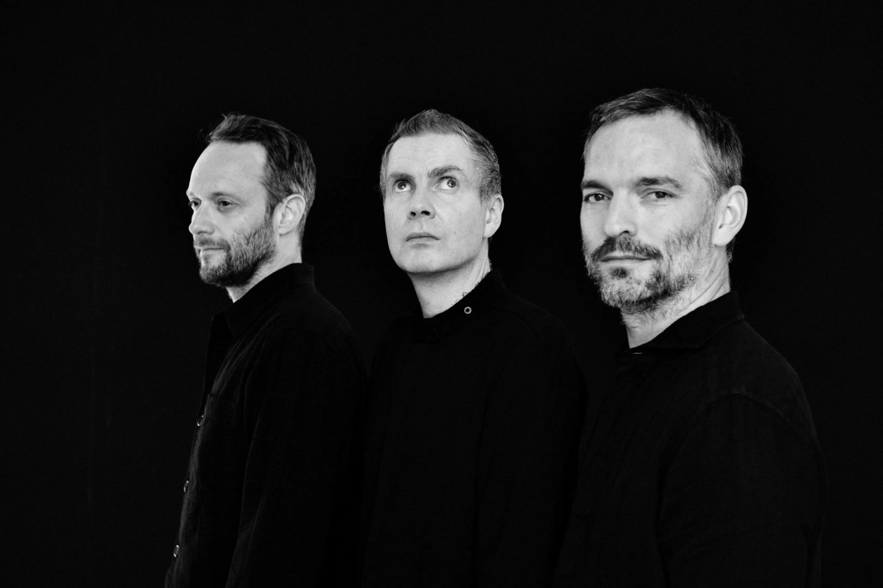 a black and white photo of the three band member's faces