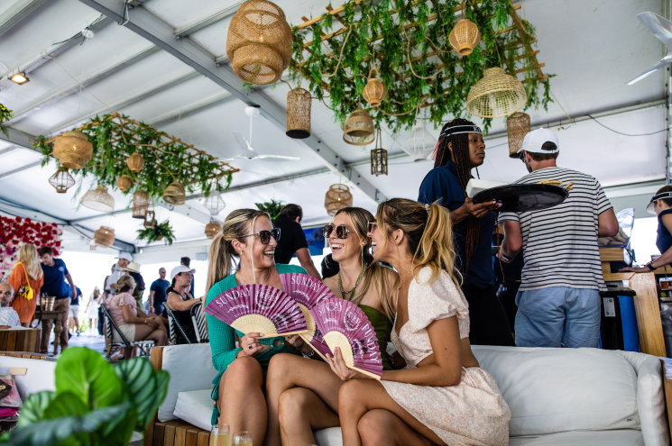 People outside at a bar with greenery