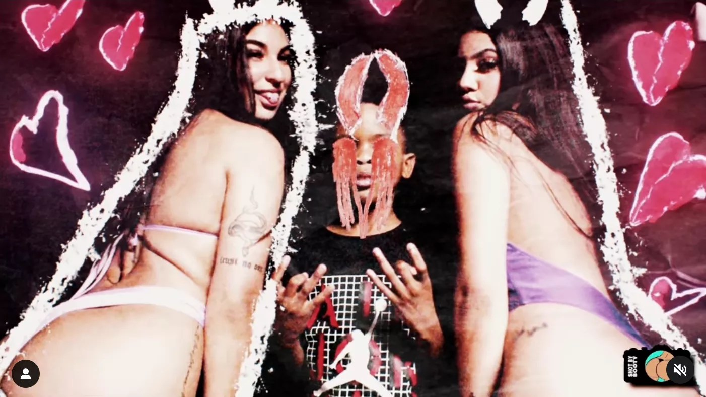 Nine-year-old rapper Lil RT with devil horns super-imposed on his head, next to two dancers in thongs