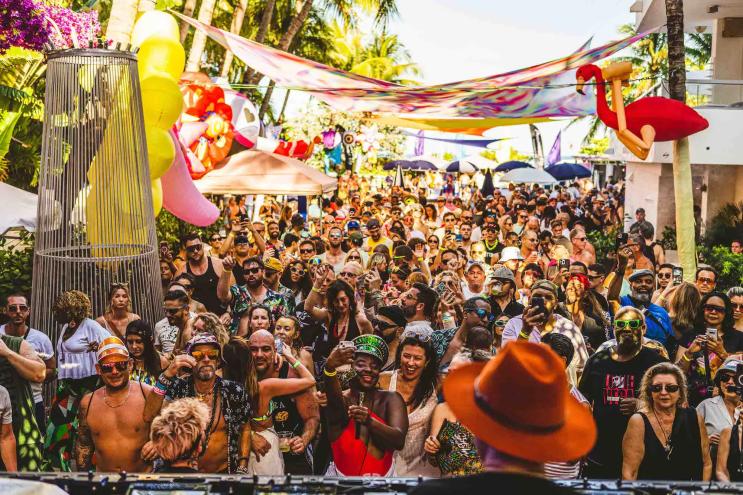 Partygoers dancing at the Glitterbox pool party