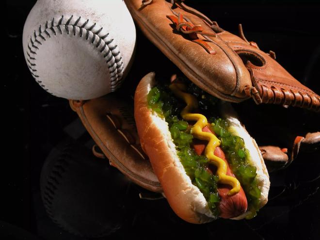 A heavily garnished wiener tucked inside a baseball glove