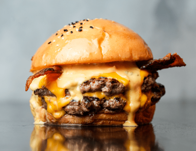 A burger with cheese and sauce