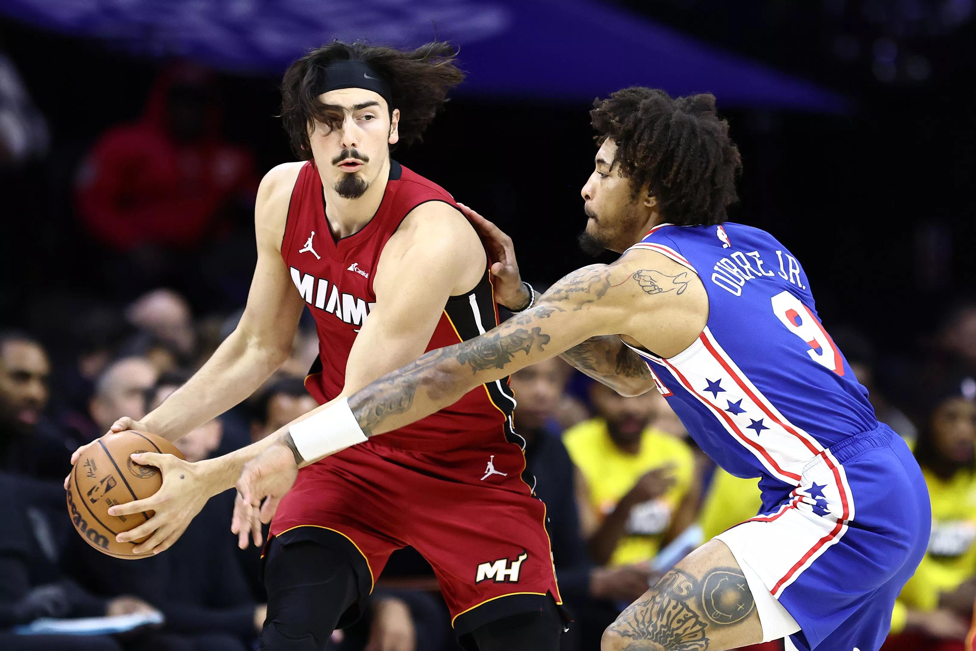 Jaime Jaquez of the Miami Heat holds the basketball away from a Philadelphia 76ers reaching out for a steal