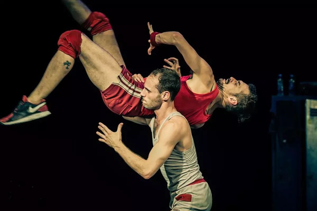 A dancer lifting another dance by the waist