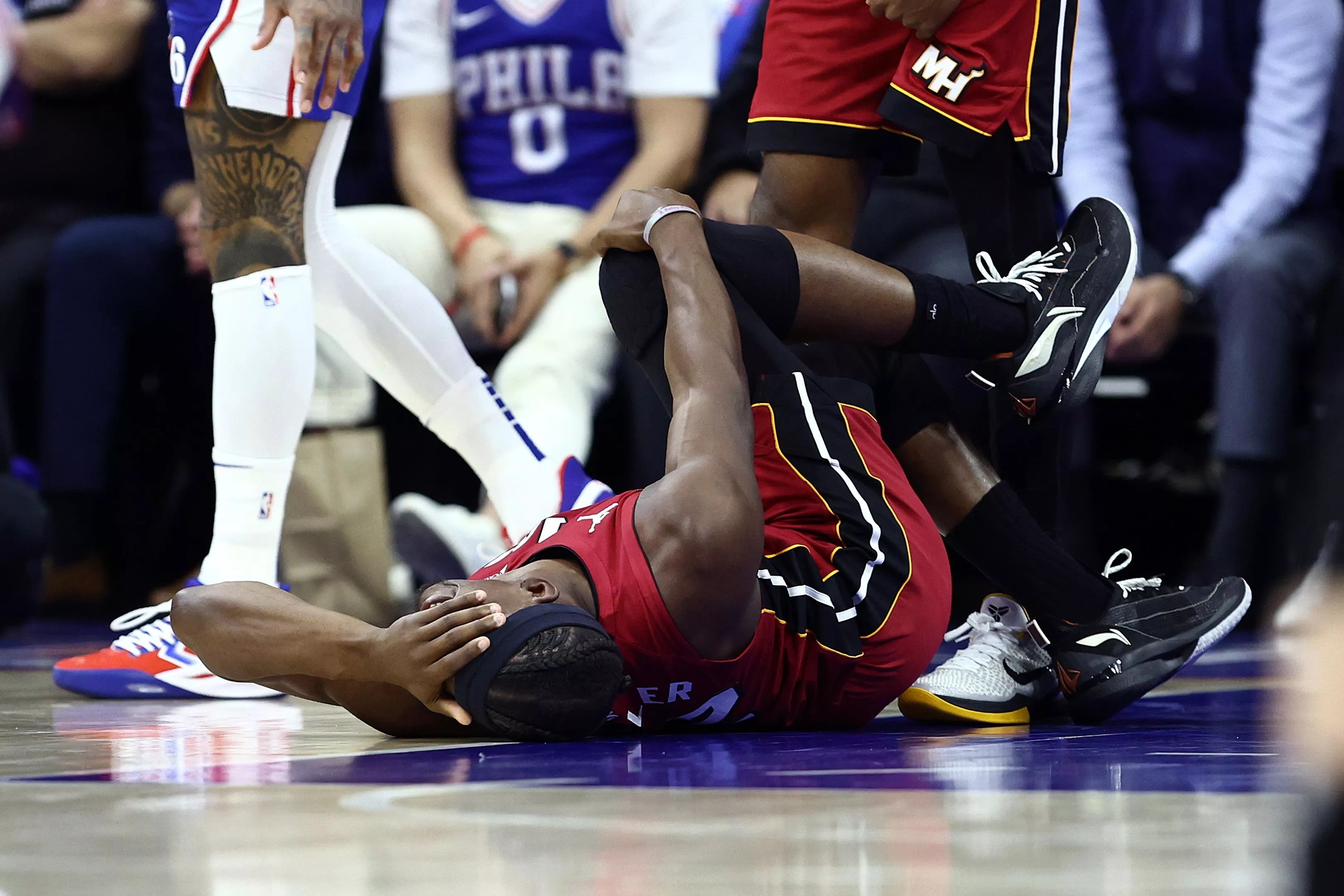 NBA star Jimmy Buter, lying on his back in pain