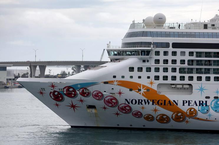 A large cruise ship docks at a Miami port
