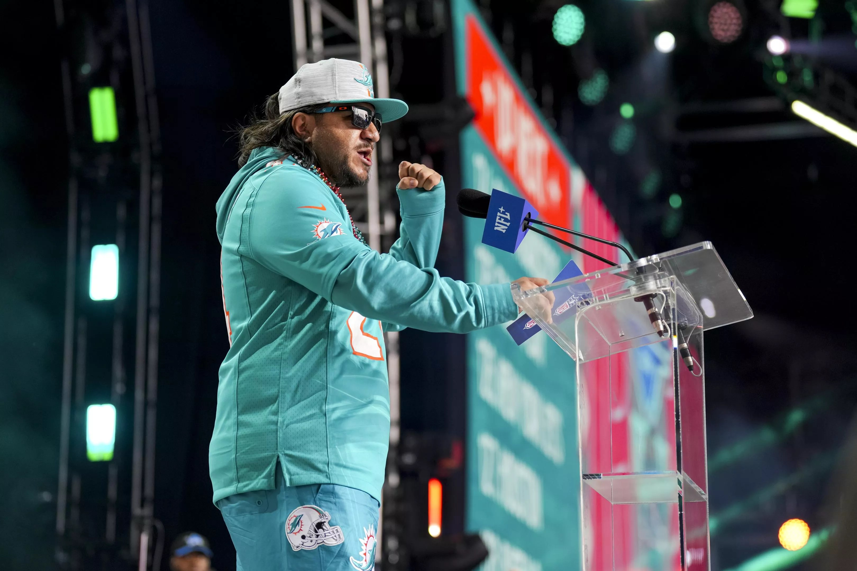 Miami Dolphins announce an NFL draft pick at the podium at Campus Martius Park and Hart Plazza