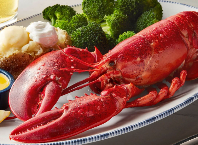 a red lobster on a plate with food