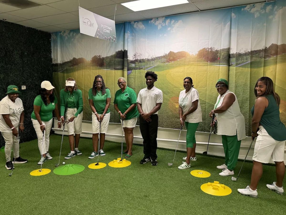 People teeing up inside Golf Miami 305