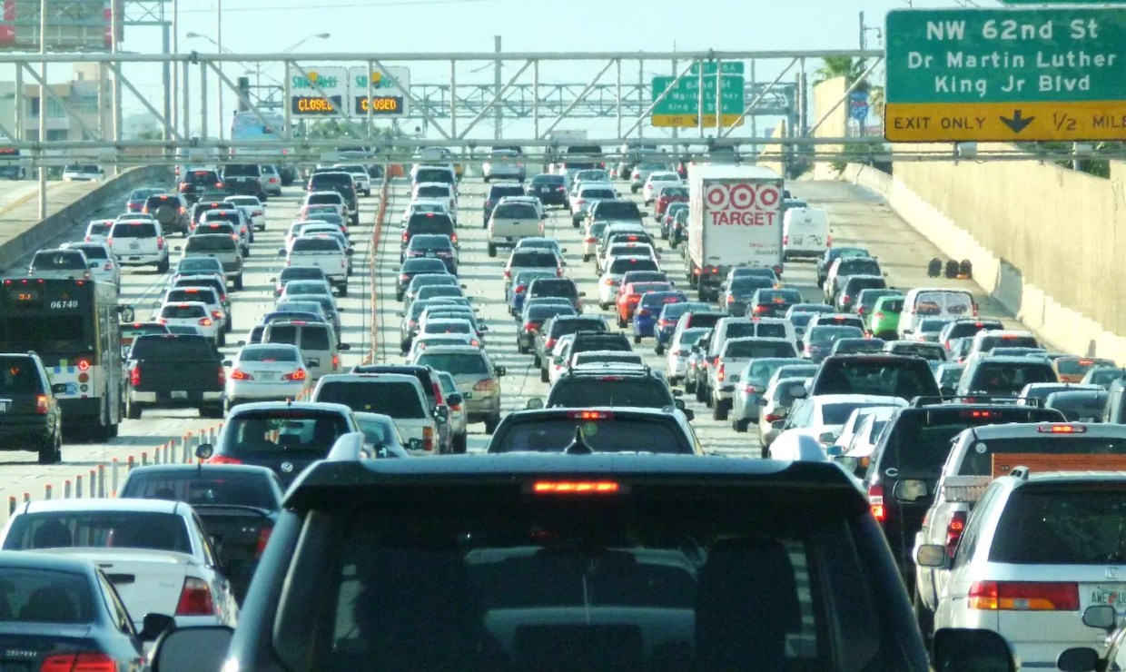 Cars on an urban stretch of interstate, as far as the eye can see