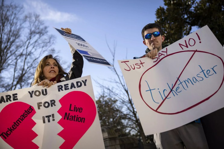 Taylor Swift fans hold fans support the split of Ticketmaster and Live Nation in front of the U.S. Capitol.