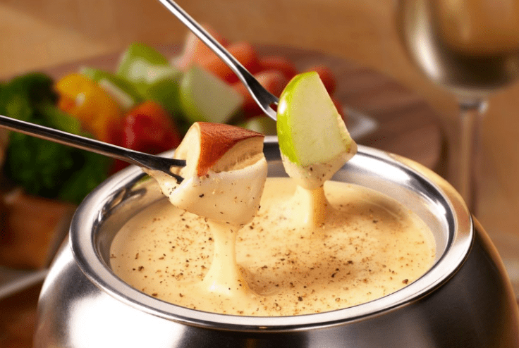 Two pieces of apples dipped in cheese