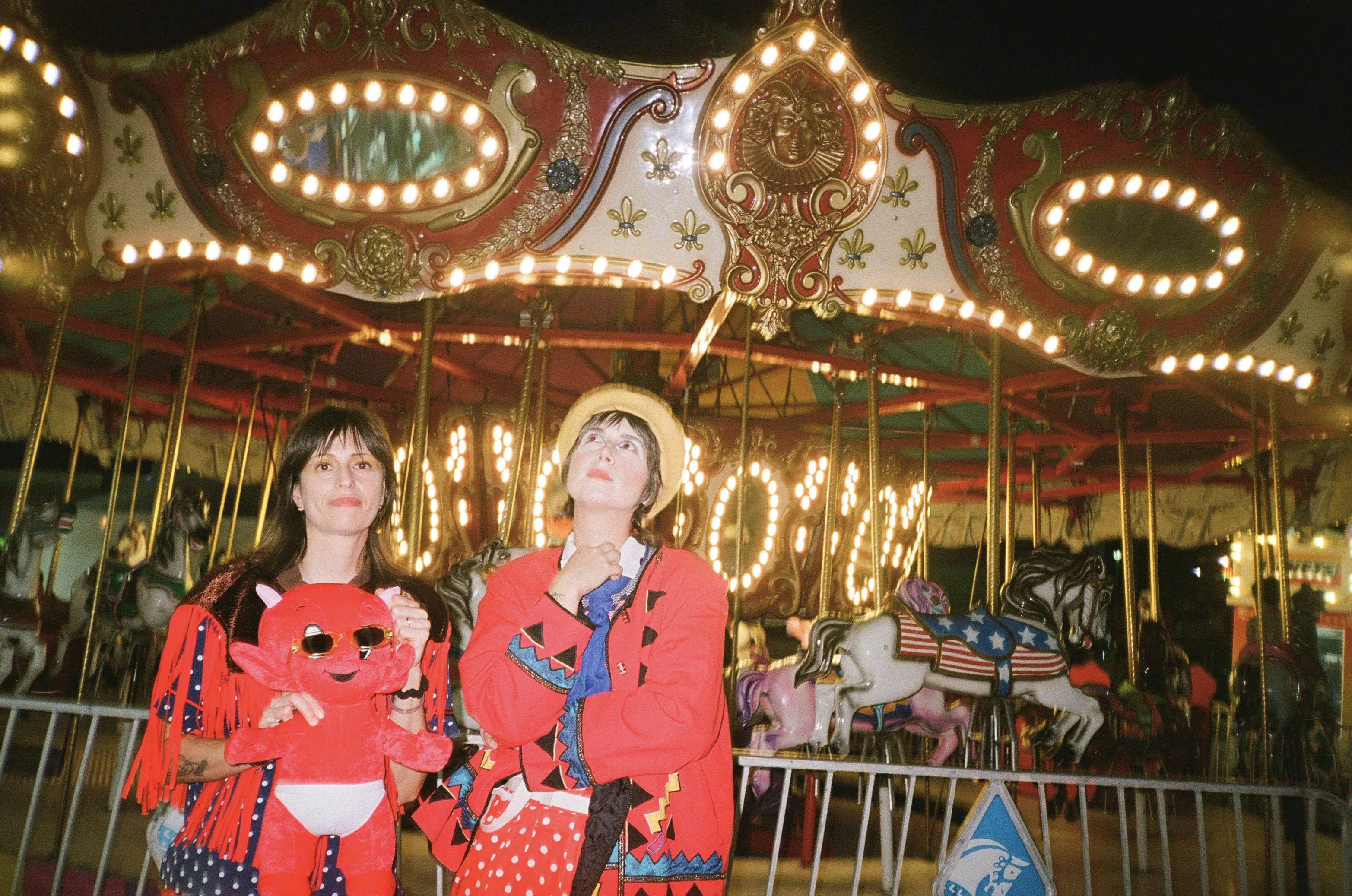 Las Nubes poses in front of a carousel