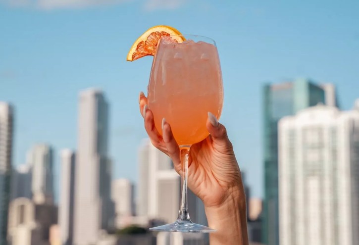 A hand holding a cocktail