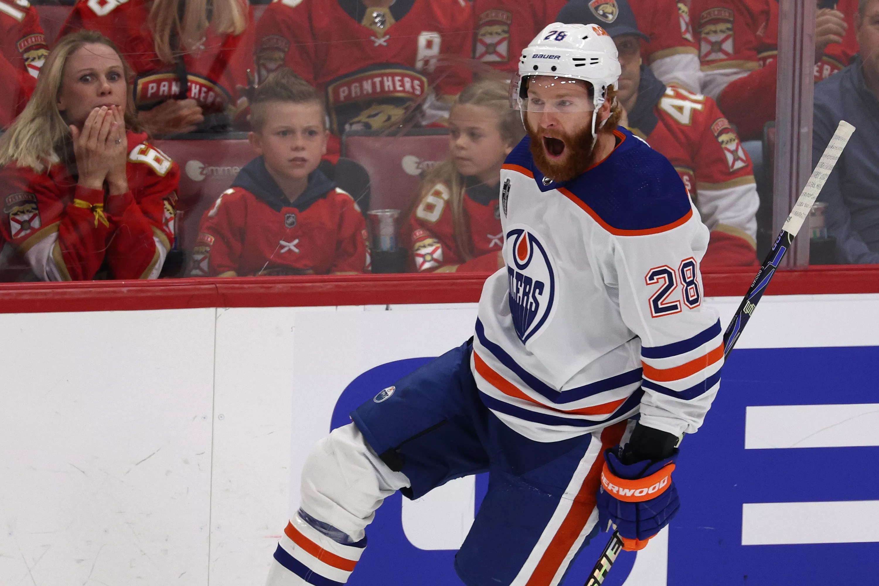Connor Brown of the Edmonton Oilers skates off in celebration after scoring in the 2024 Stanley Cup Finals. The fans in the background look dejected