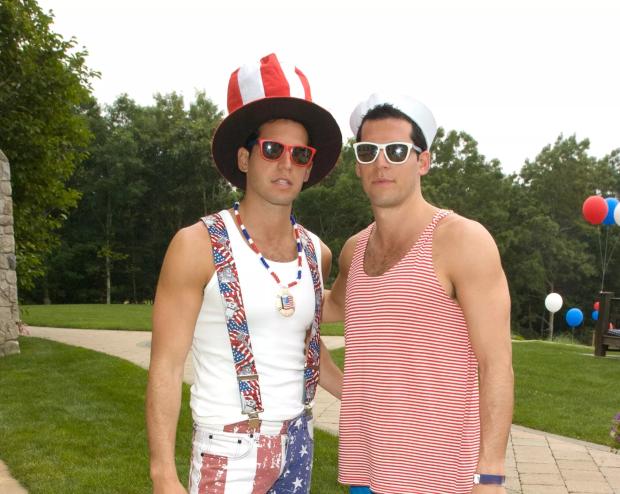 The Alexander twins dressed in patriotic costumes outside a large mansion