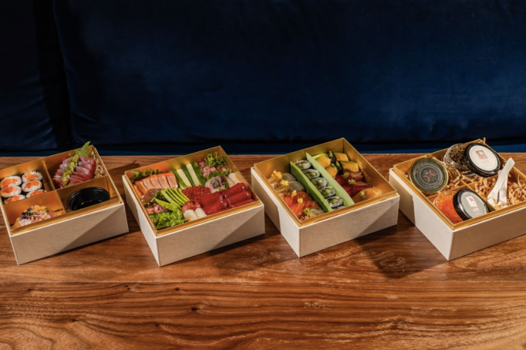 sushi boxes on wood table