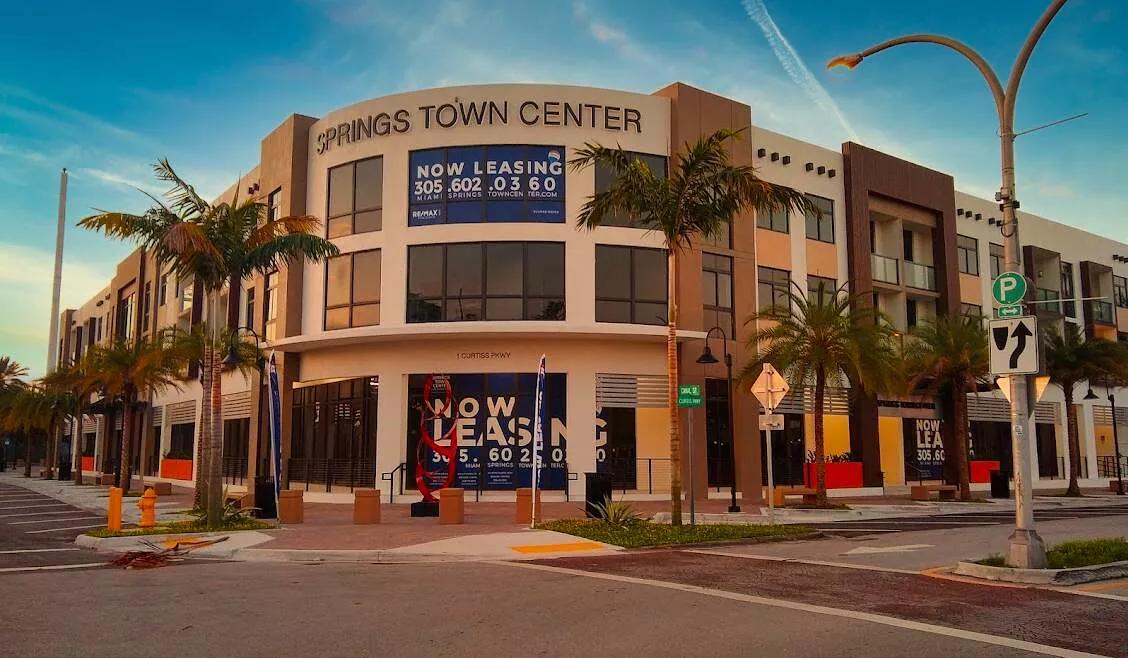 The front entrance to a newly built, modern-look mixed-use in Miami Springs