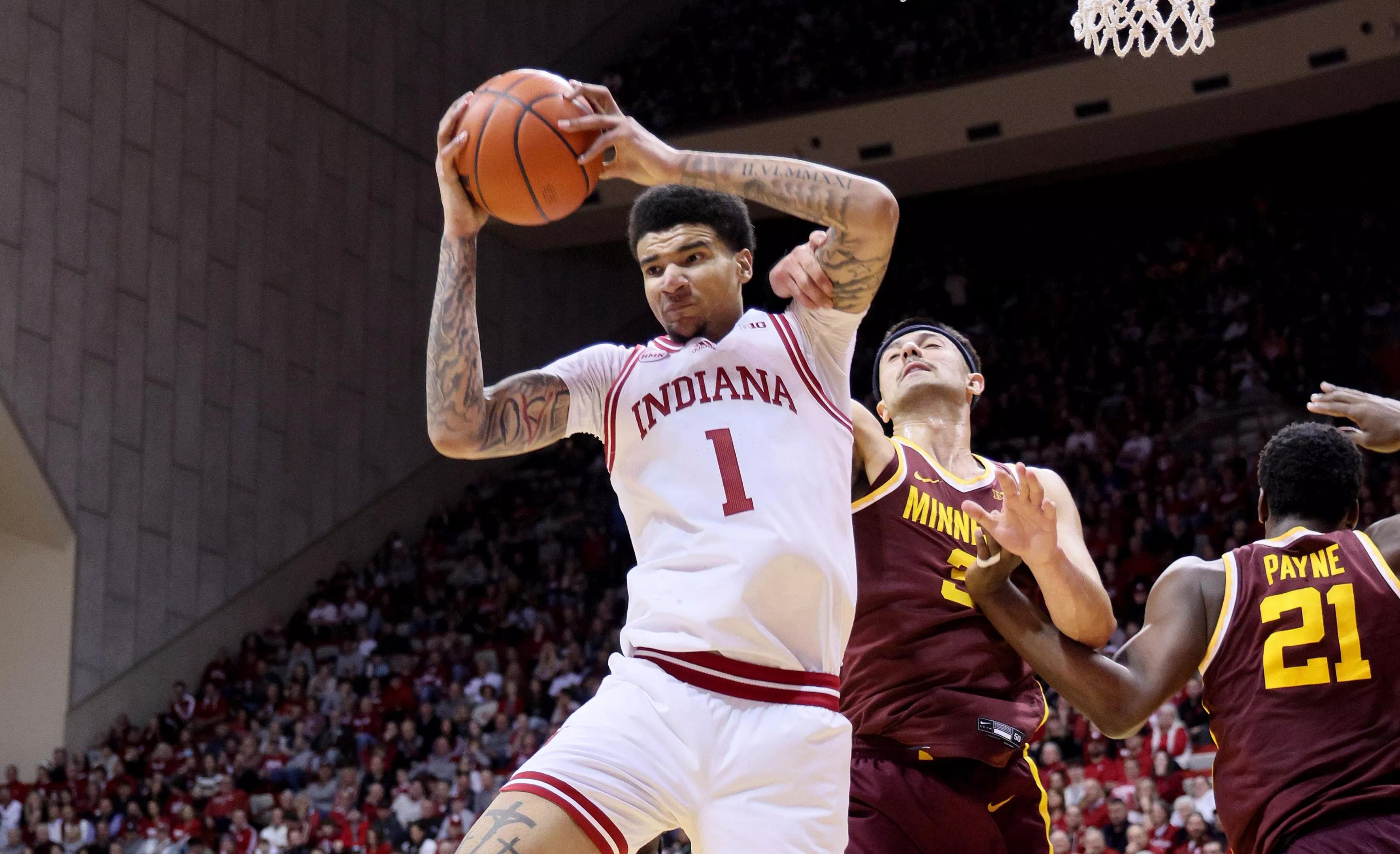 Kel'el Ware pulls in a rebound with a ball over his head