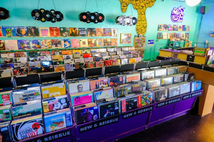photo of records for sale at a record shop with aqua walls