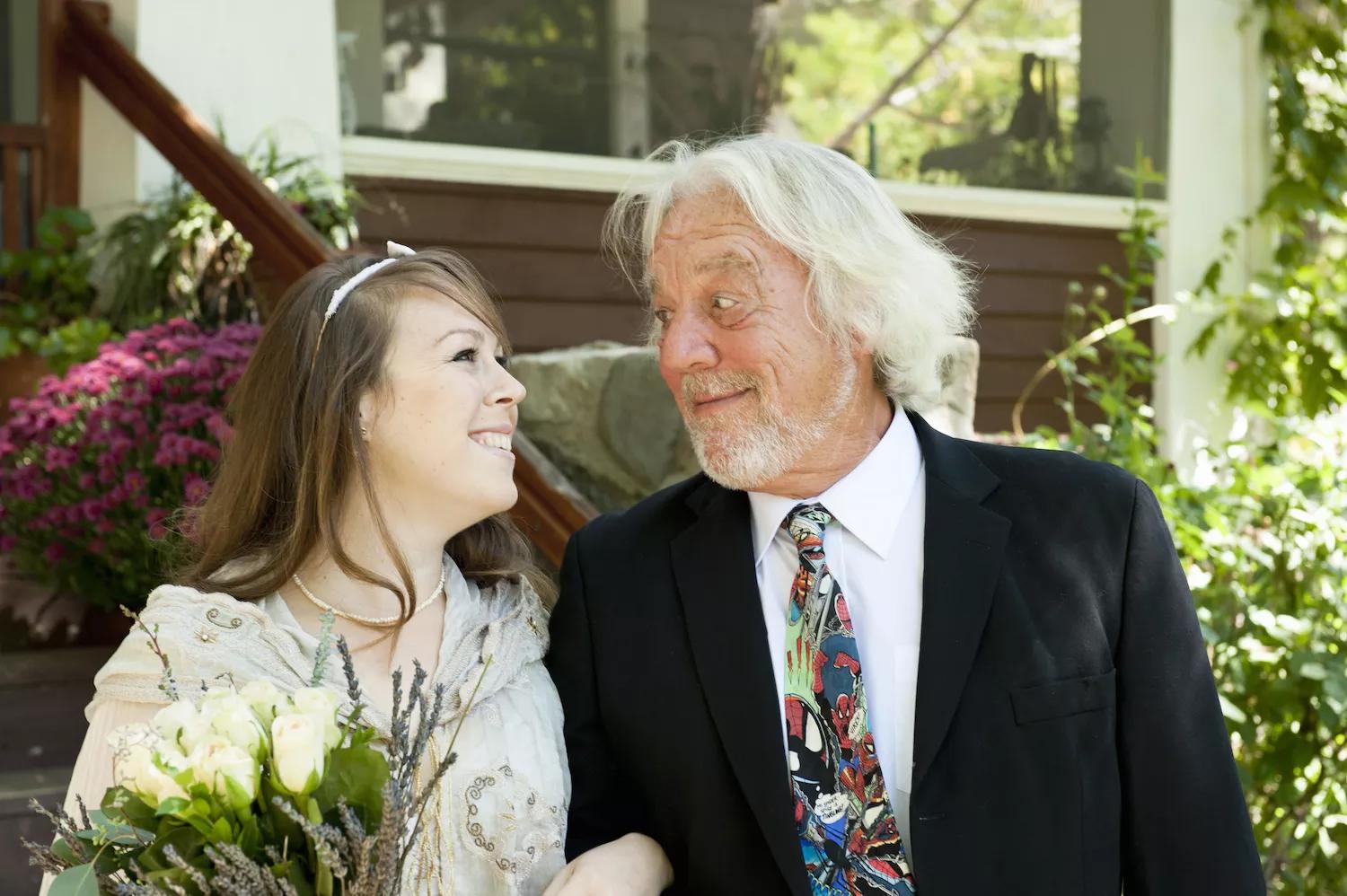color stock photo of a young bride with an old bearded man