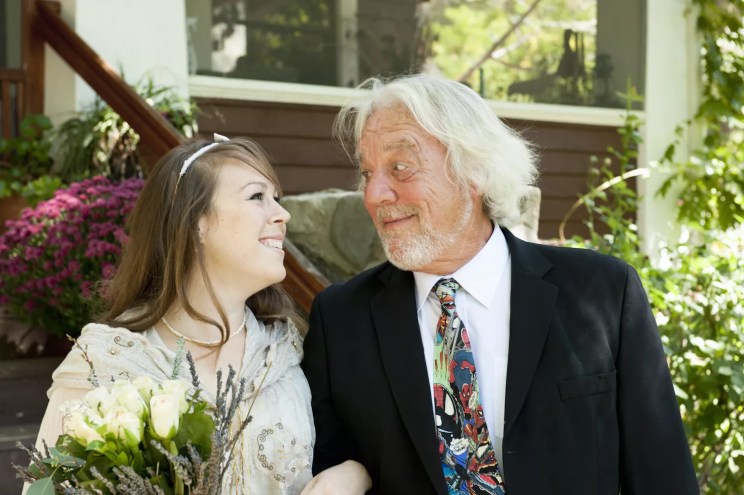 color stock photo of a young bride with an old bearded man