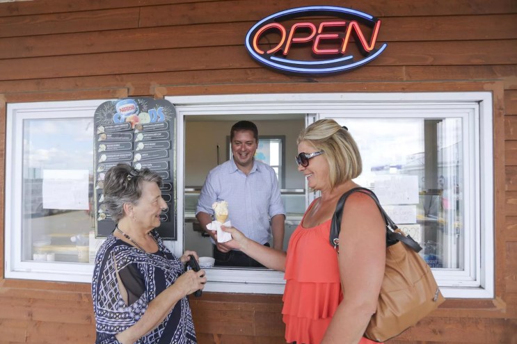 two women in front of a service window at an ice cream stand