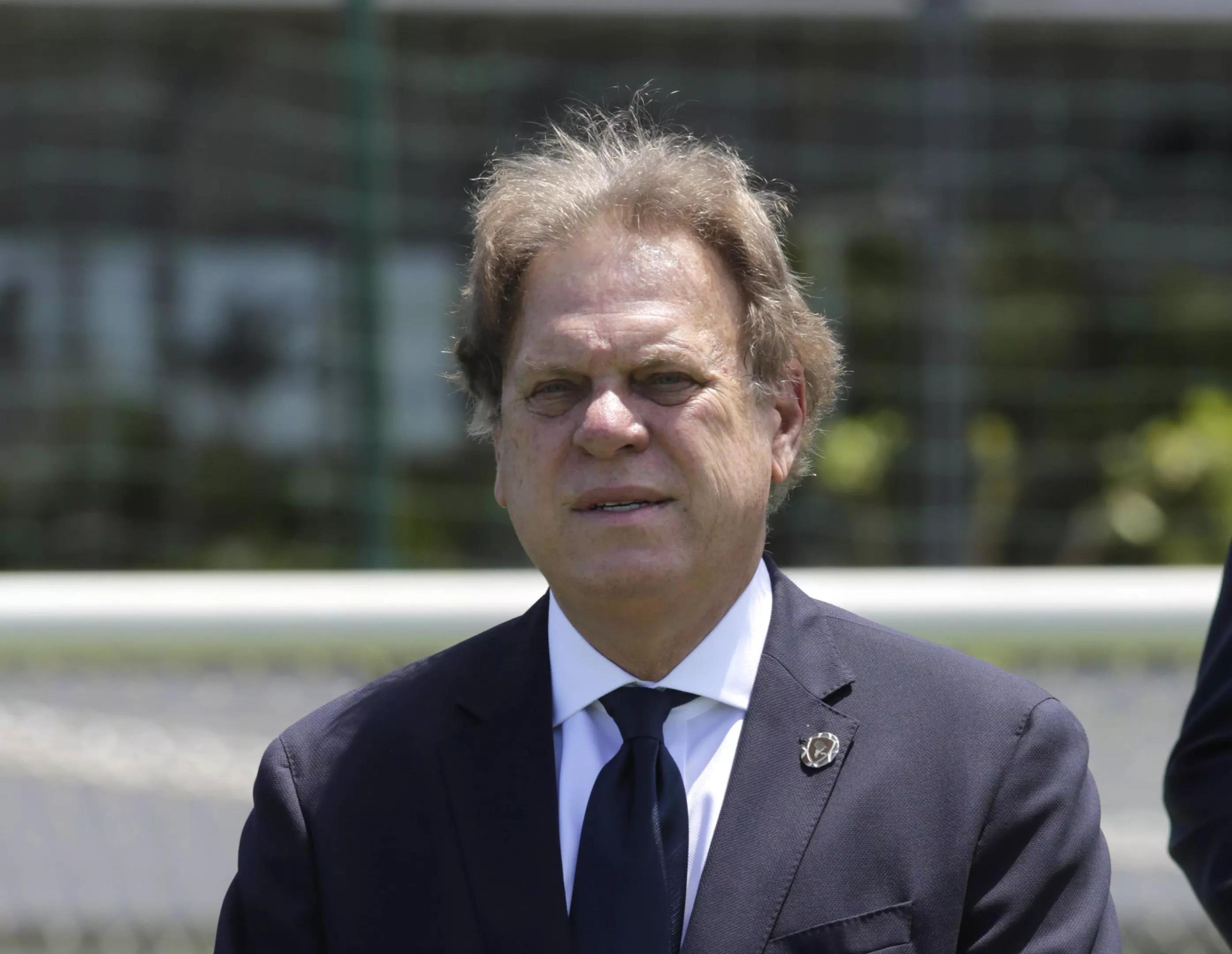 Ramon Jesurun poses for a photo while wearing a suit