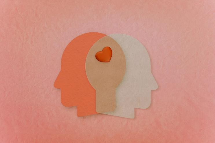 An illustration of two heads sharing a heart