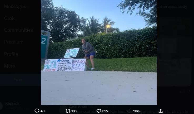 Punter crouches in front of signs