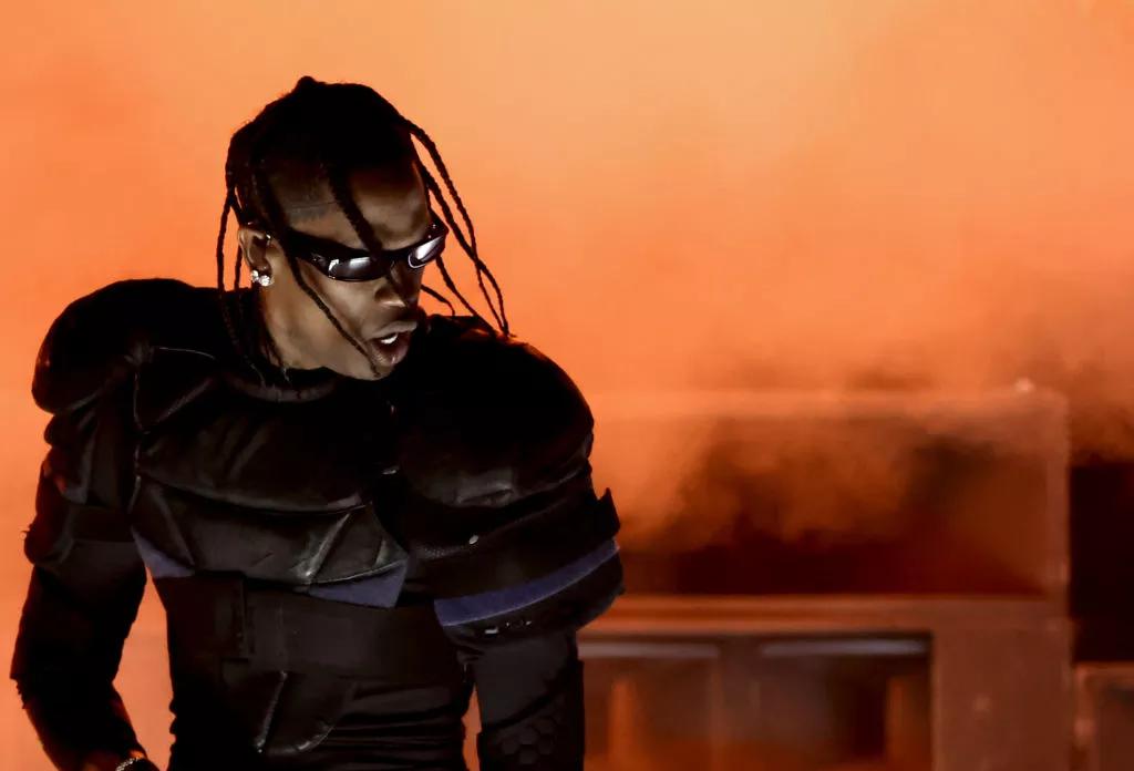 Rapper Travis Scott in sunglasses and armor-like clothing on stage at the Grammy Awards