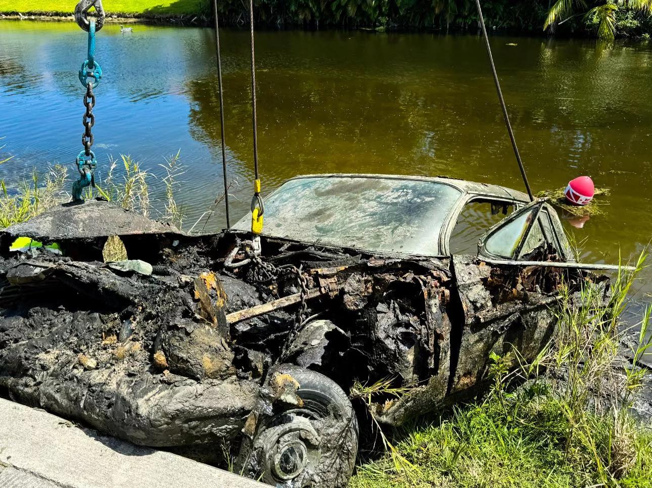 A severely rusted, 1960s car that was just pulled from a South Florida canal after it was submerged for decades