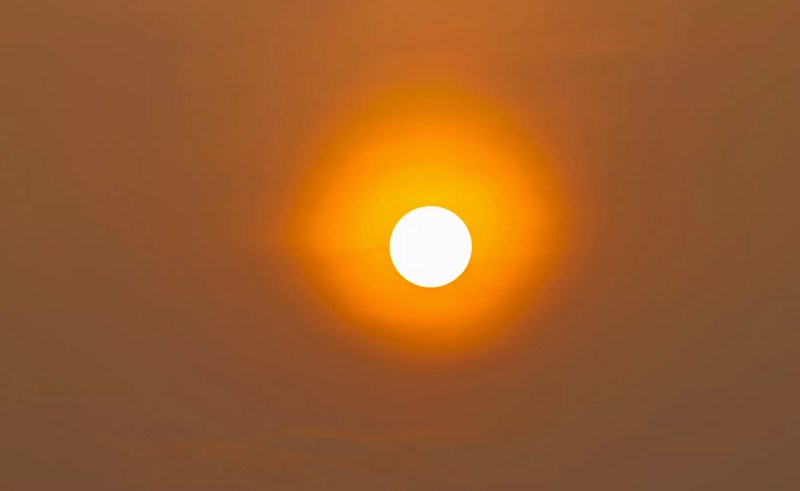 Large orange sun in the sky