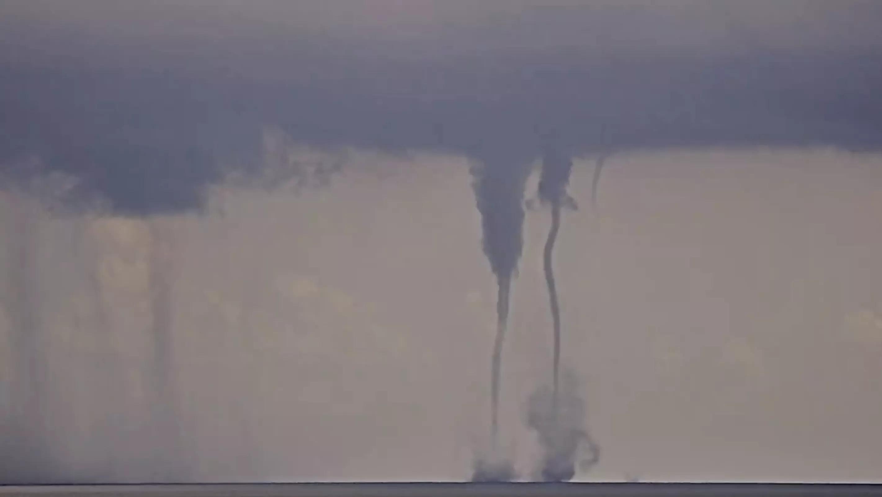 screenshot of twin waterspouts coming together and separating off the Atlantic coast in South Florida