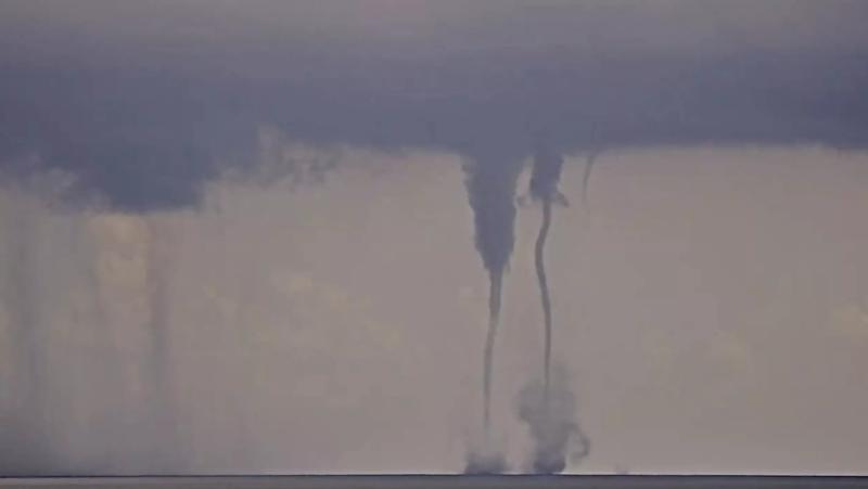 screenshot of twin waterspouts coming together and separating off the Atlantic coast in South Florida